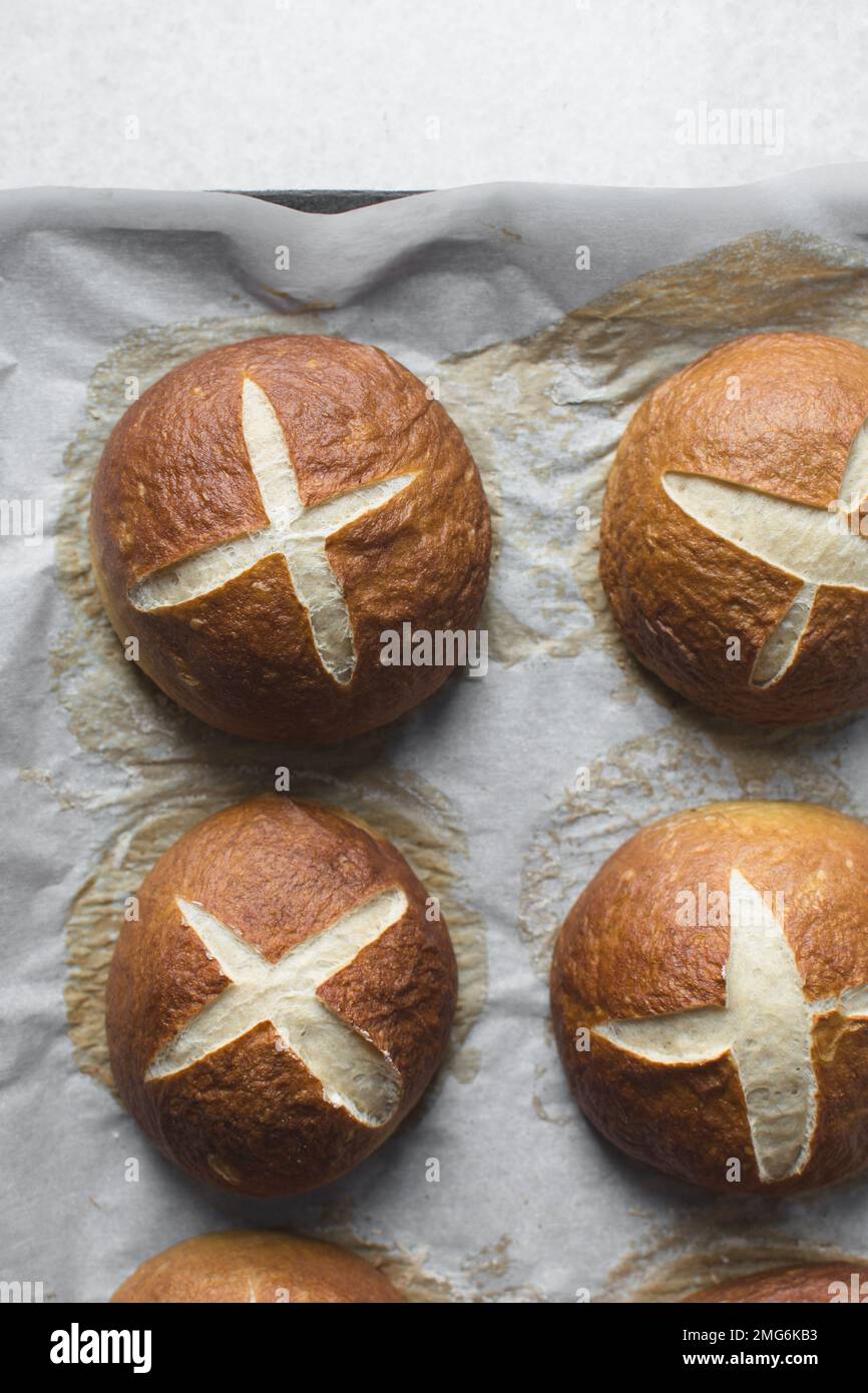 Top view of Pretzel buns on a parchment lined baking sheet, German