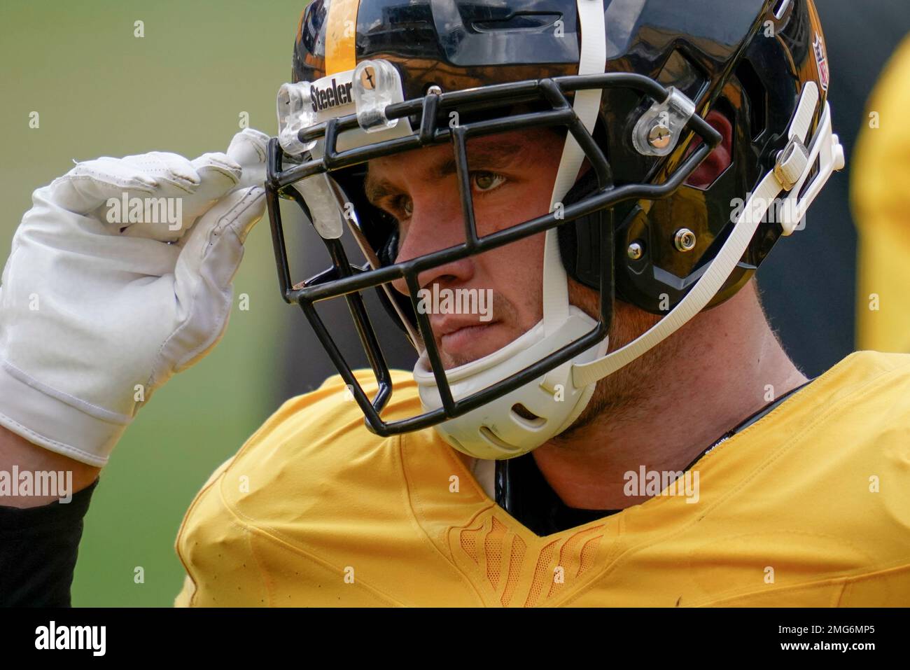 Pittsburgh Steelers linebacker T.J. Watt (90) grabs his mouth guard before  going through a drill during an NFL football training camp practice,  Monday, Aug. 24, 2020, in Pittsburgh. Watt is coming off