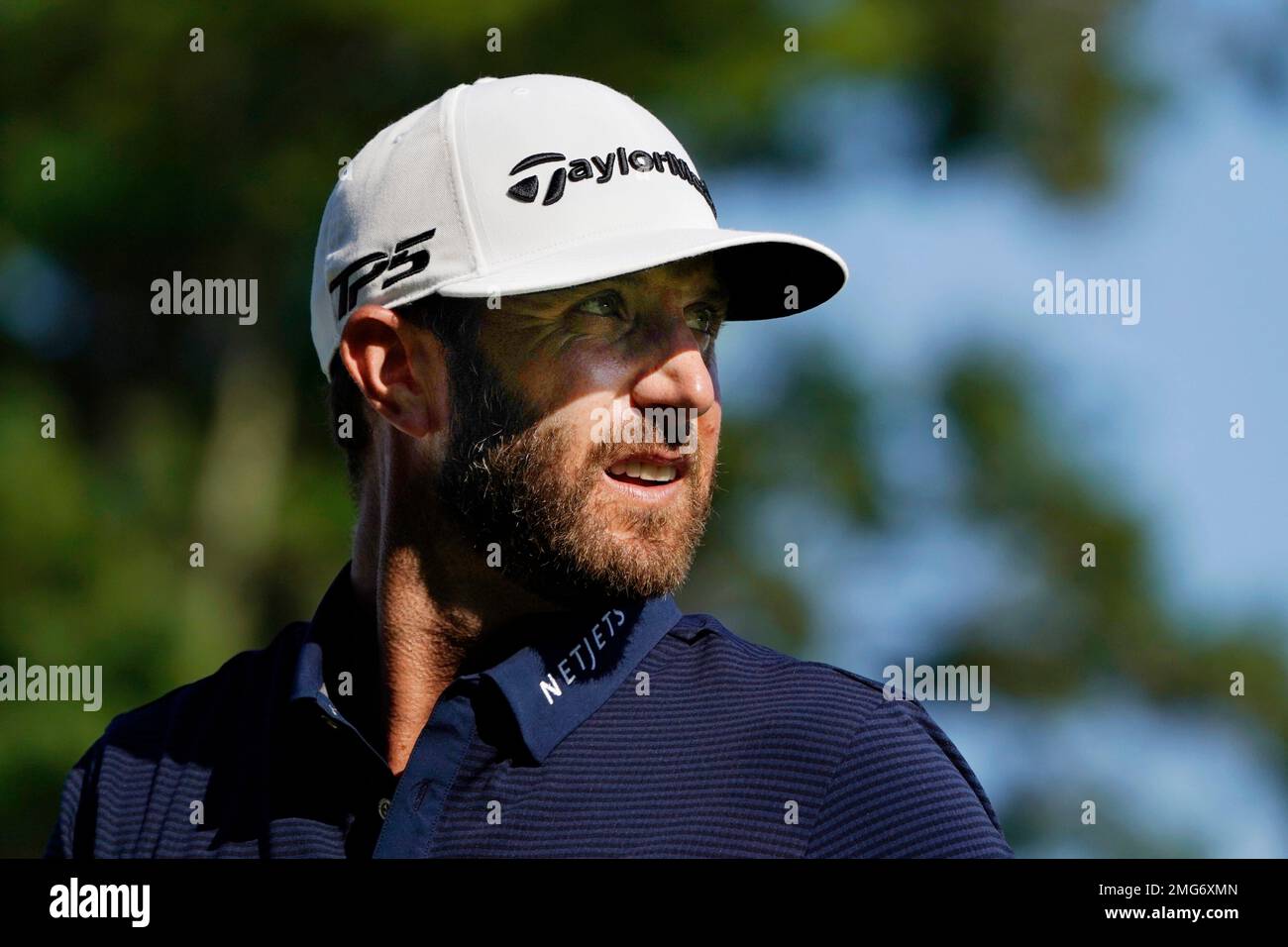 Dustin Johnson watches his shot on the 12th tee during the final round