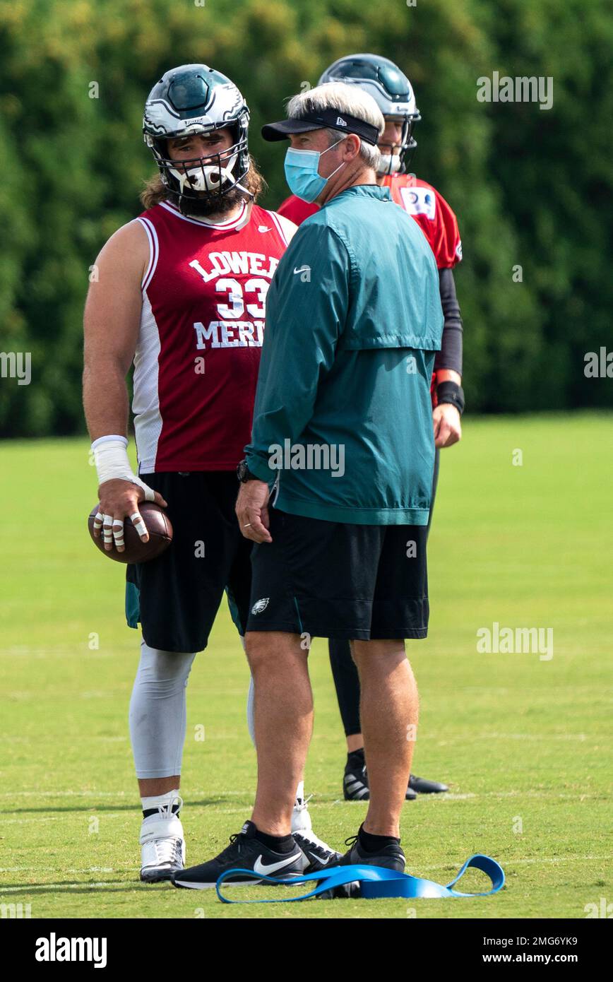 Philadelphia Eagles center Jason Kelce, who is wearing a Kobe Bryant Lower  Merion High School jersey, left, talks with head coach Doug Pederson,  right, during an NFL football practice, Sunday, Aug. 23
