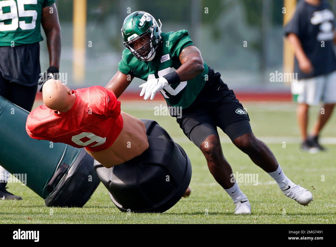 New York Jets linebacker Jordan Jenkins practices drills during a