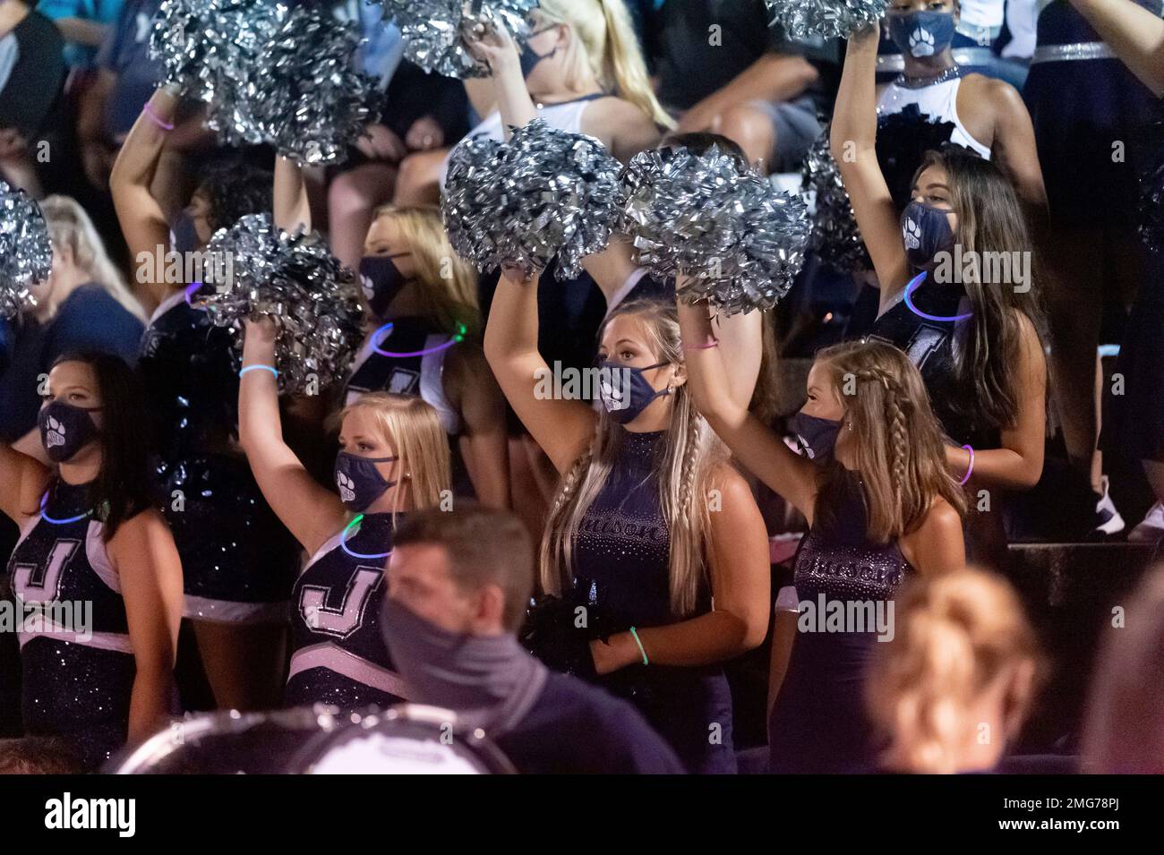The Jemison band's flag girls wear masks as they cheer on their team at
