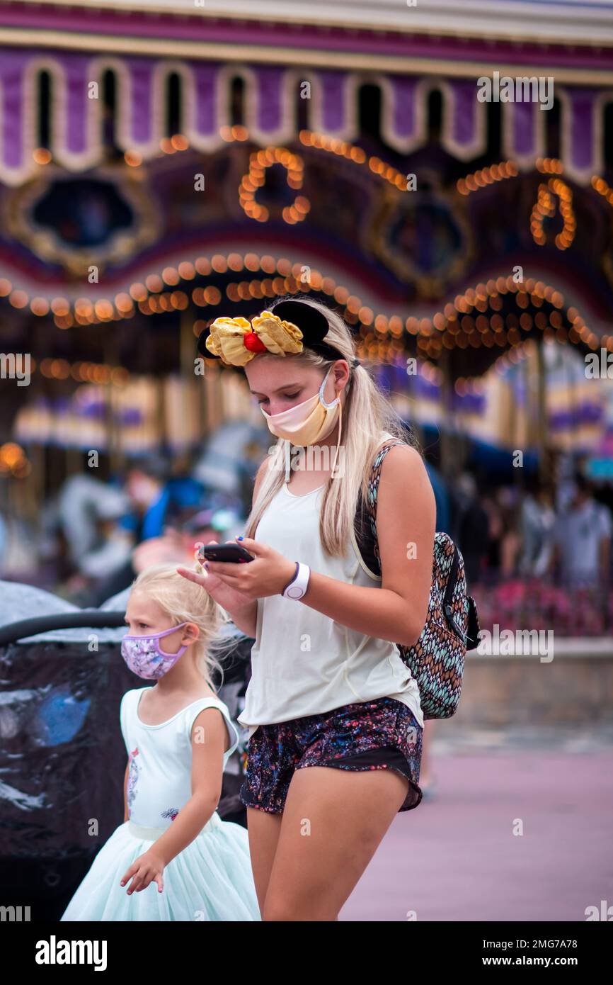 Guests wear required face masks due to the Covid19 pandemic at Walt Disney World Resort's Magic