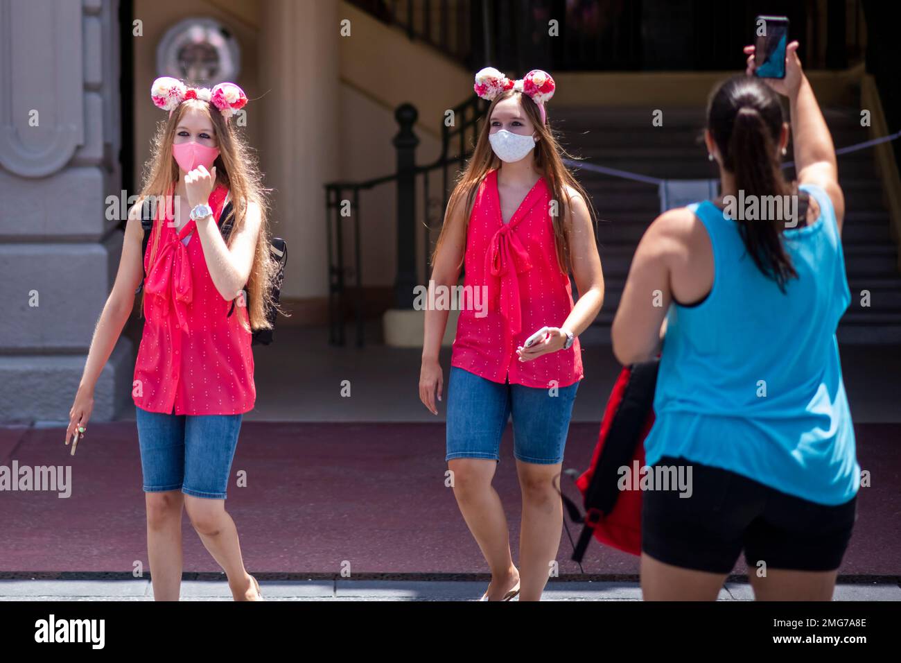 Guests wear required face masks due to the Covid19 pandemic at Walt Disney World Resort's Magic