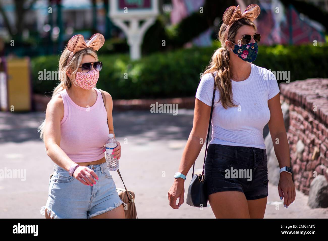 Guests wear required face masks due to the Covid19 pandemic at Walt Disney World Resort's Magic