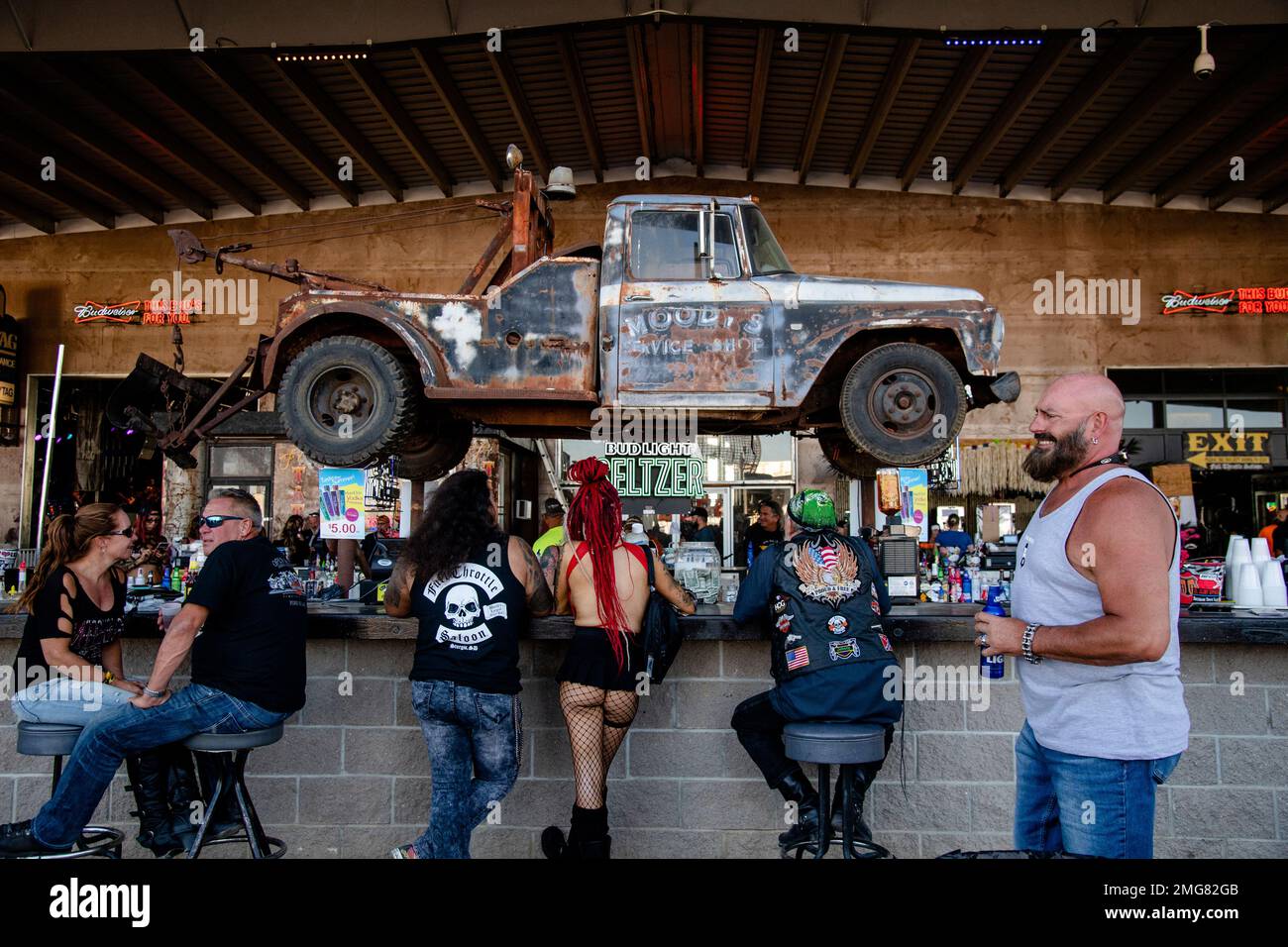 Patrons sit at the bar at the Full Throttle Saloon during the 80th
