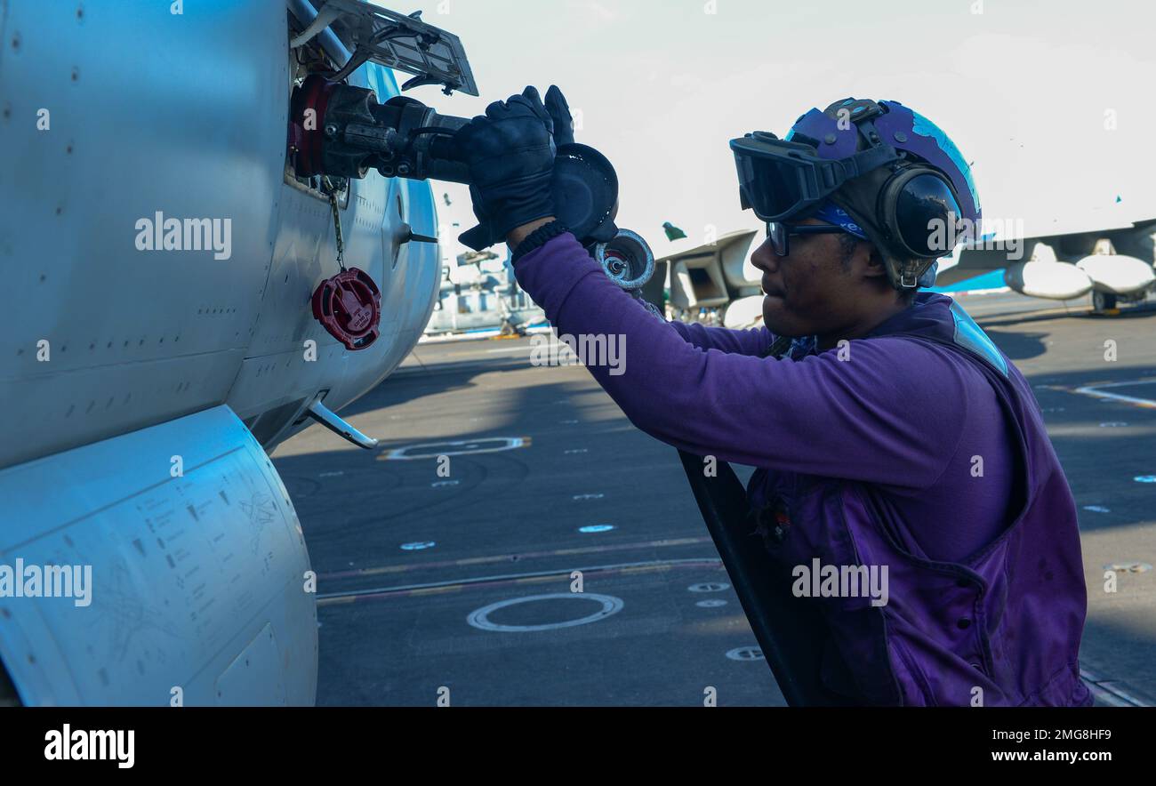 220822-N-FB730-1047 MEDITERRANEAN SEA (Aug. 22, 2022) Airman Jahquawn Clayton, from San Francisco, fuels an F/A-18E Super Hornet on the flight deck of the Nimitz-class aircraft carrier USS Harry S. Truman (CVN 75), Aug. 22, 2022. The Harry S. Truman Carrier Strike Group is on a scheduled deployment in the U.S. Naval Forces Europe area of operations, employed by U.S. Sixth Fleet to defend U.S., allied and partner interests. Stock Photo
