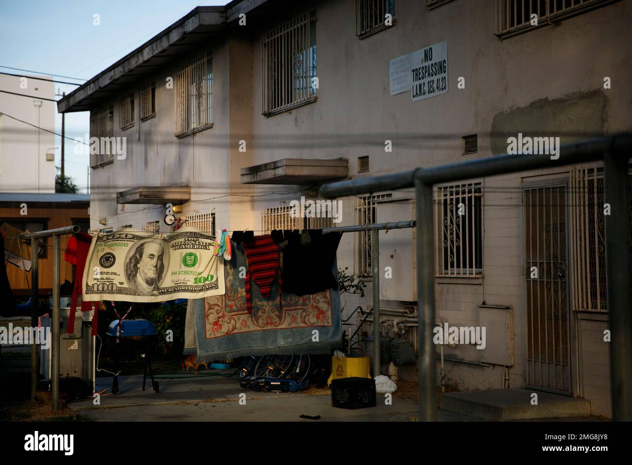 Laundry hangs on a clothesline outside an apartment building at the