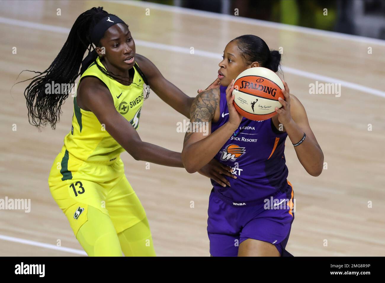 Phoenix Mercury's Kia Vaughn, right, looks past the defense of Seattle