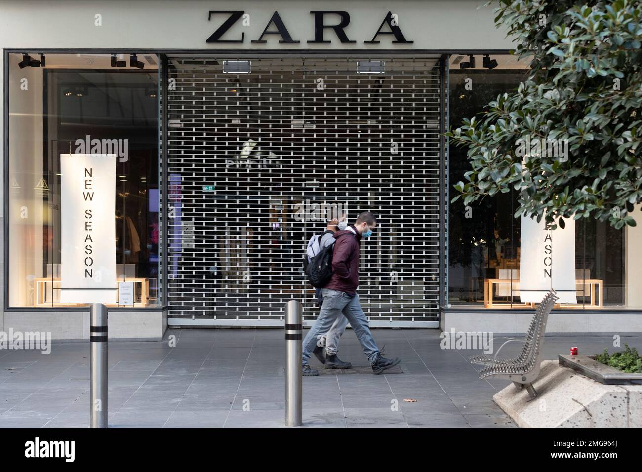 Pedestrians walk past a shuttered Zara clothing outlet in the usually busy Bourke  street mall as lockdown due to the continuing spread of the coronavirus  starts in Melbourne, Wednesday, Aug. 5, 2020.