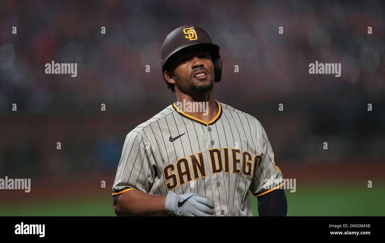 San Diego Padres' Francisco Mejia is congratulated in the dugout after  scoring on an error by Colorado Rockies' Trevor Story during the sixth  inning of a baseball game Thursday, Aug. 8, 2019