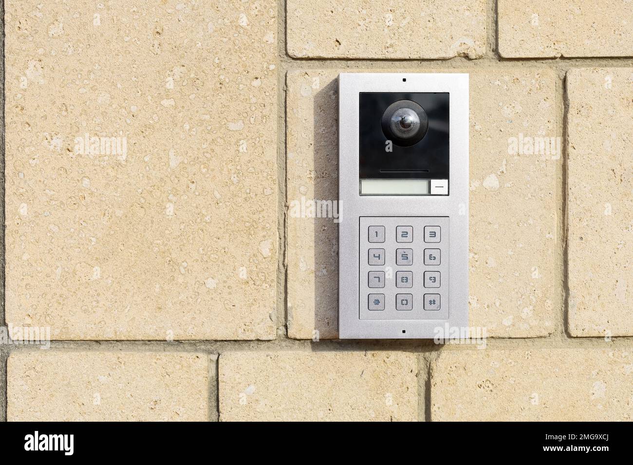 Modern intercom on brick wall Stock Photo