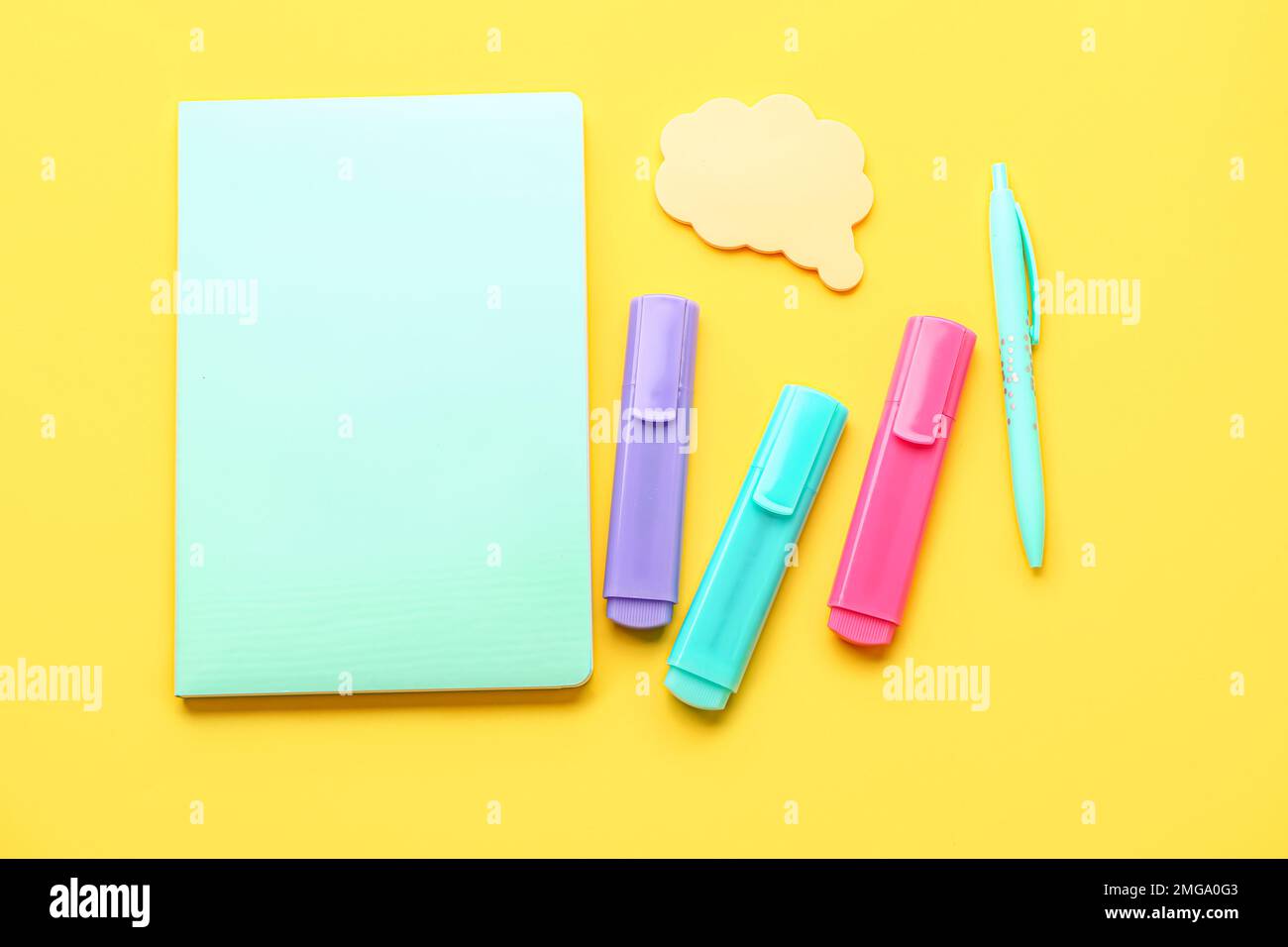 Notebook, pen, markers and sticky notes on yellow background Stock Photo