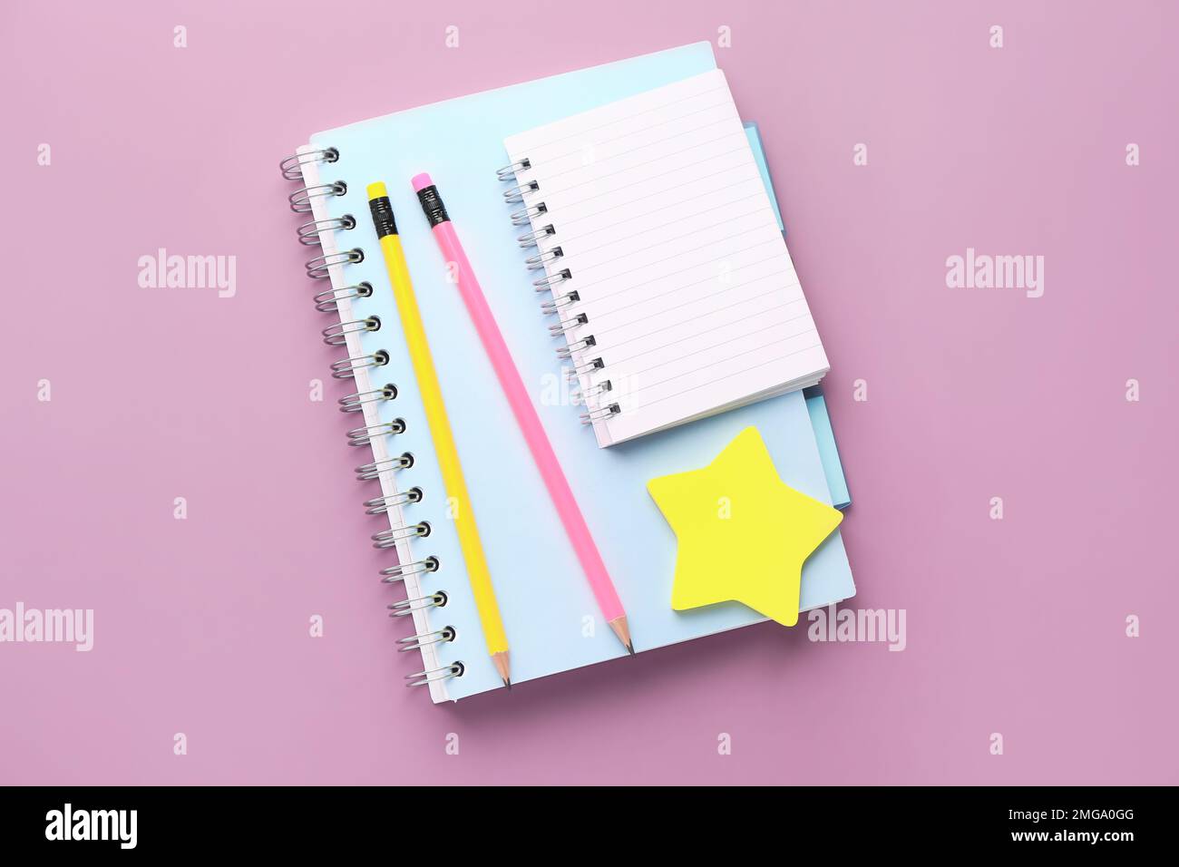 Notebooks, pencils and sticky notes on lilac background Stock Photo
