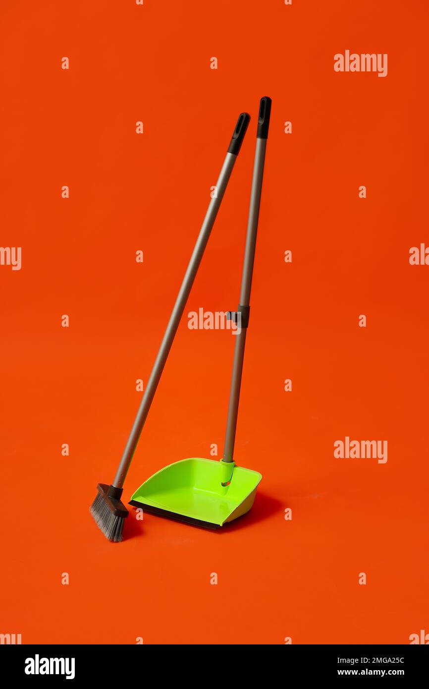 Plastic dustpan with cleaning broom on color background Stock Photo Alamy