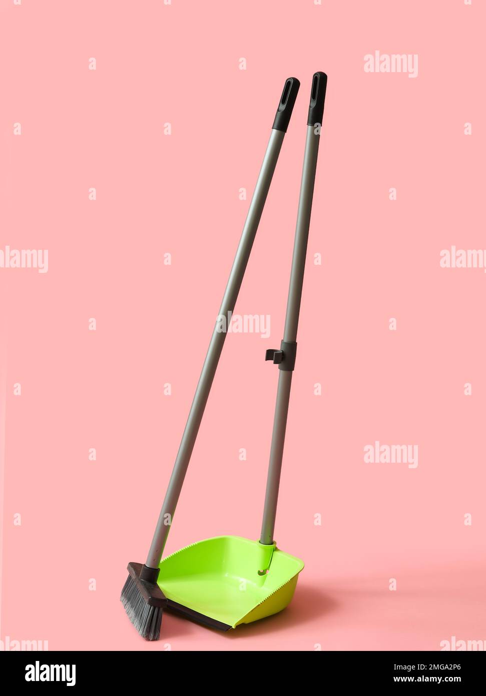Dustpan with cleaning broom on pink background Stock Photo Alamy
