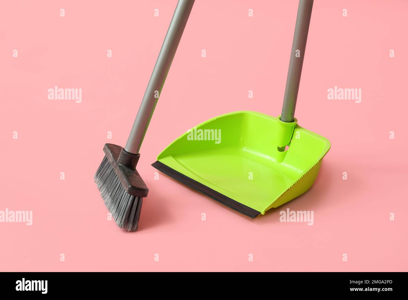 Dustpan with cleaning broom on pink background Stock Photo Alamy
