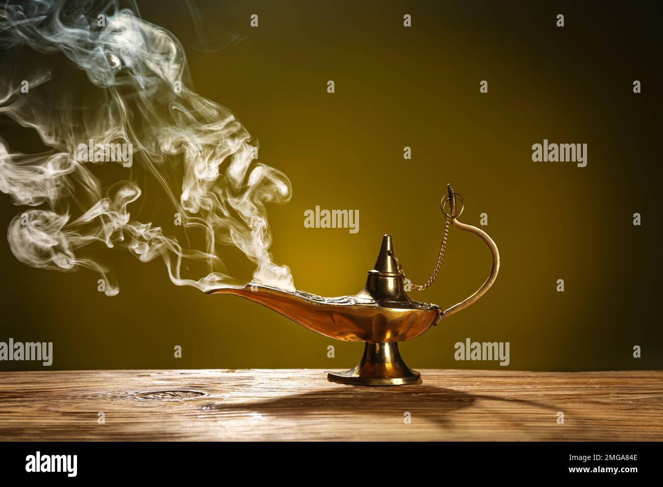 Aladdin lamp of wishes with smoke for Ramadan on table against dark ...