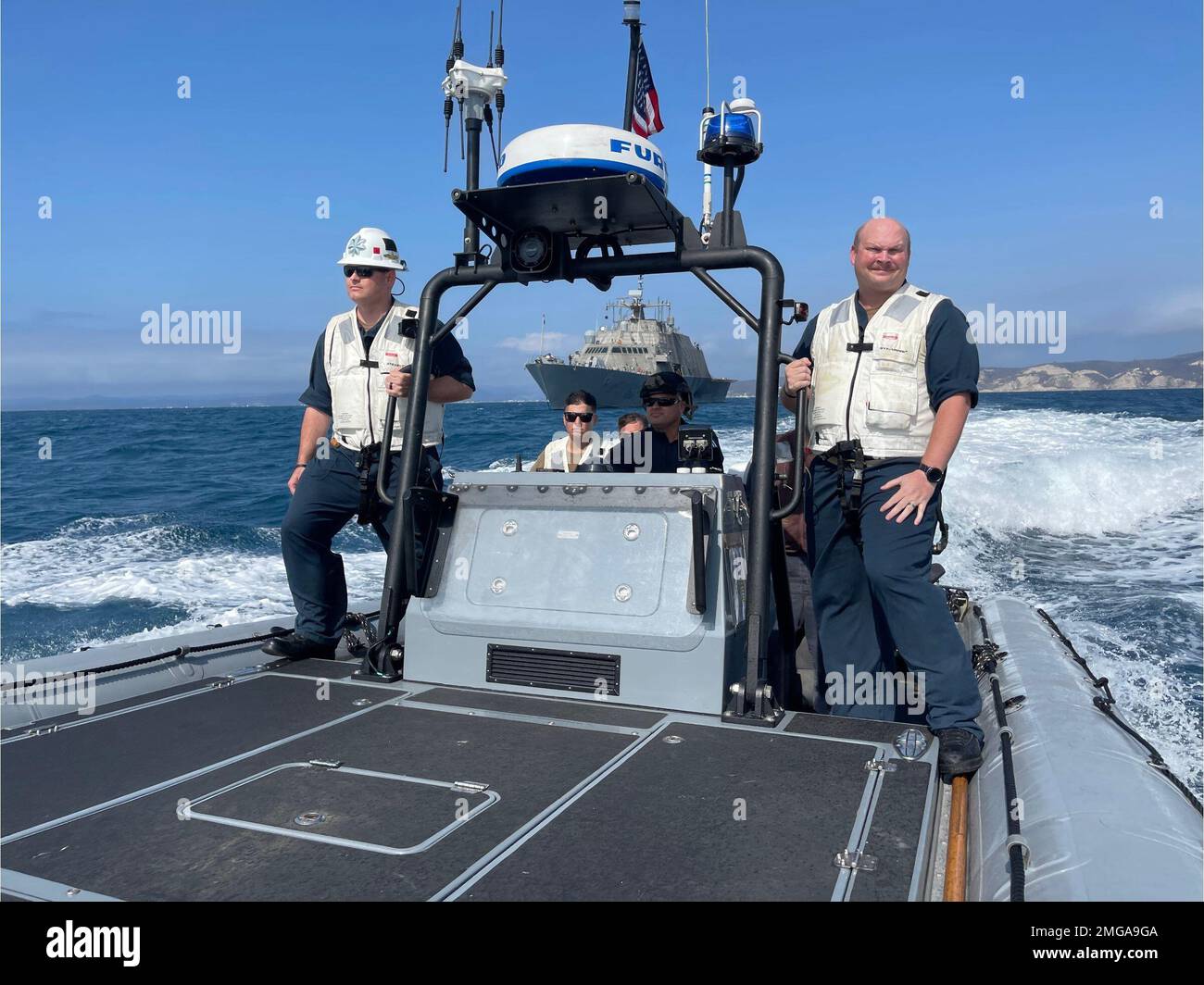 220822-N-N3764-2002  MANTA, Ecuador - (Aug. 22, 2022) -- Sailors assigned to the Freedom-variant littoral combat ship USS Billings (LCS 15) along with U.S. Coast Guard Law Enforcement Detachment 401 conduct small boat operations in an 11-meter rigid-hull inflatable boat (RHIB) attached to the ship off the coast of Manta, Ecuador, Aug. 22, 2022. Billings is deployed to the U.S. 4th Fleet area of operations to support Joint Interagency Task Force South’s mission, which includes counter-illicit drug trafficking missions in the Caribbean and Eastern Pacific. Stock Photo