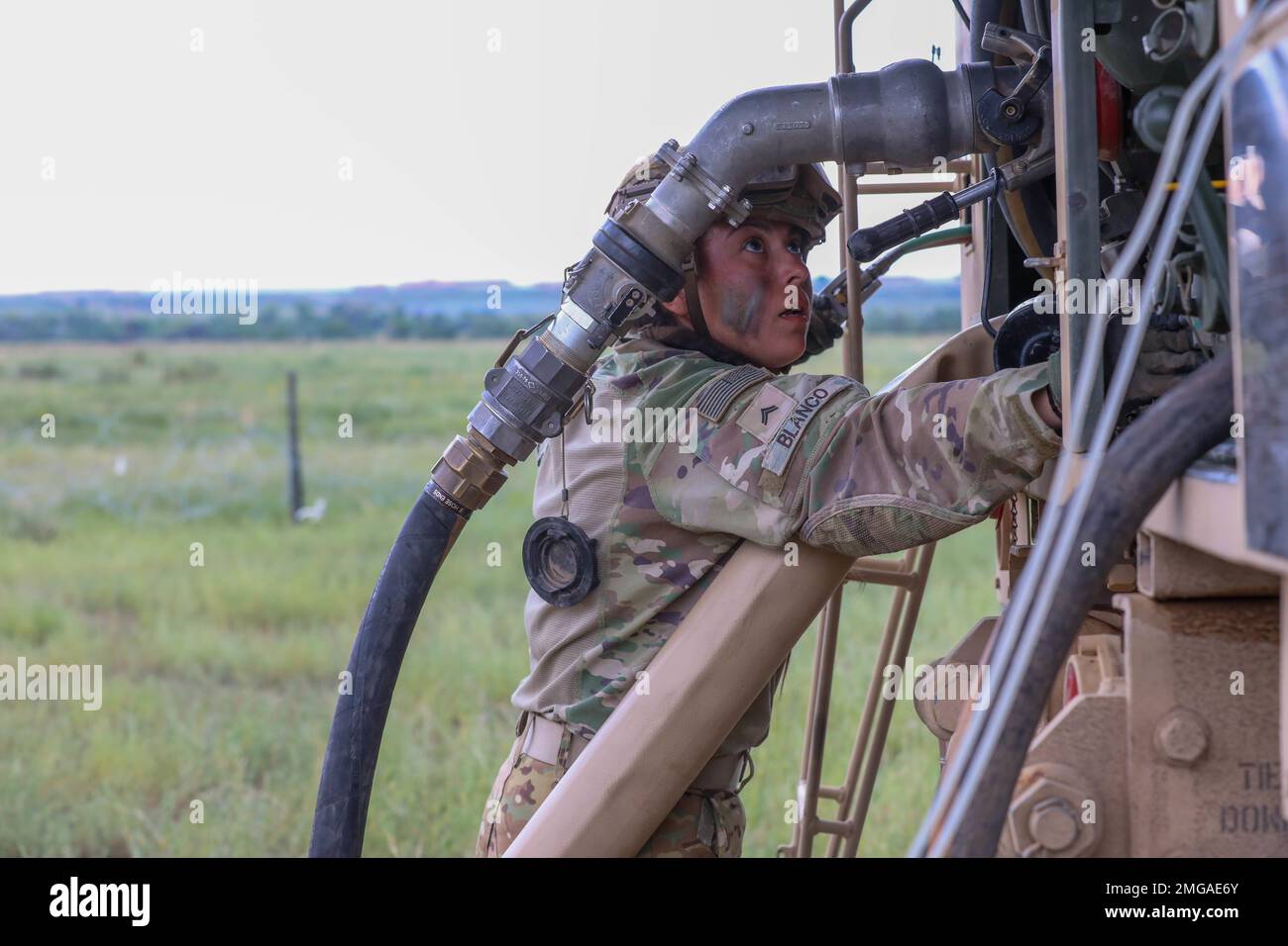 Cpl. Kaylynne Blanco, a petroleum supply specialist assigned to 404th Aviation Support Battalion, 4th Combat Aviation Brigade, 4th Infantry Division assists in a fuel malfunction during field training at the Forward Arming Refueling Point, FARP, in Fort Carson, Colorado, Aug. 22, 2022. The field training was to enhance the unit's reaction to combat the enemy for all levels of support. Stock Photo