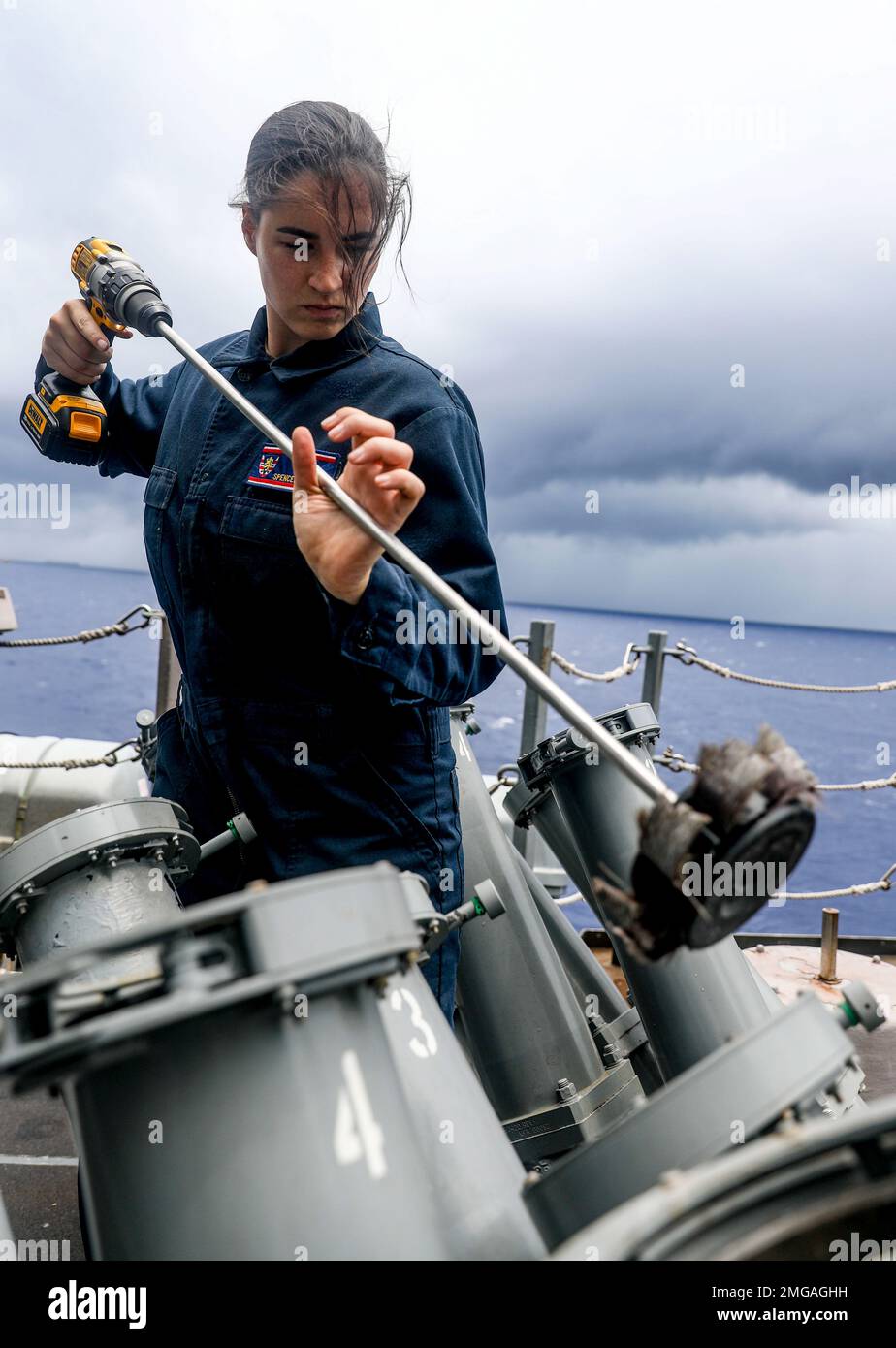 PHILIPPINE SEA (Aug. 22, 2022) – Lt. j.g. Spencer McVeigh, from San Diego, cleans the launching tubes of a Mark 53 decoy launching system during routine maintenance aboard the Arleigh Burke-class guided missile-destroyer USS Barry (DDG 52). Barry is assigned to Commander, Task Force 71/Destroyer Squadron (DESRON) 15, the Navy’s largest forward-deployed DESRON and the U.S. 7th Fleet’s principal surface force. Stock Photo