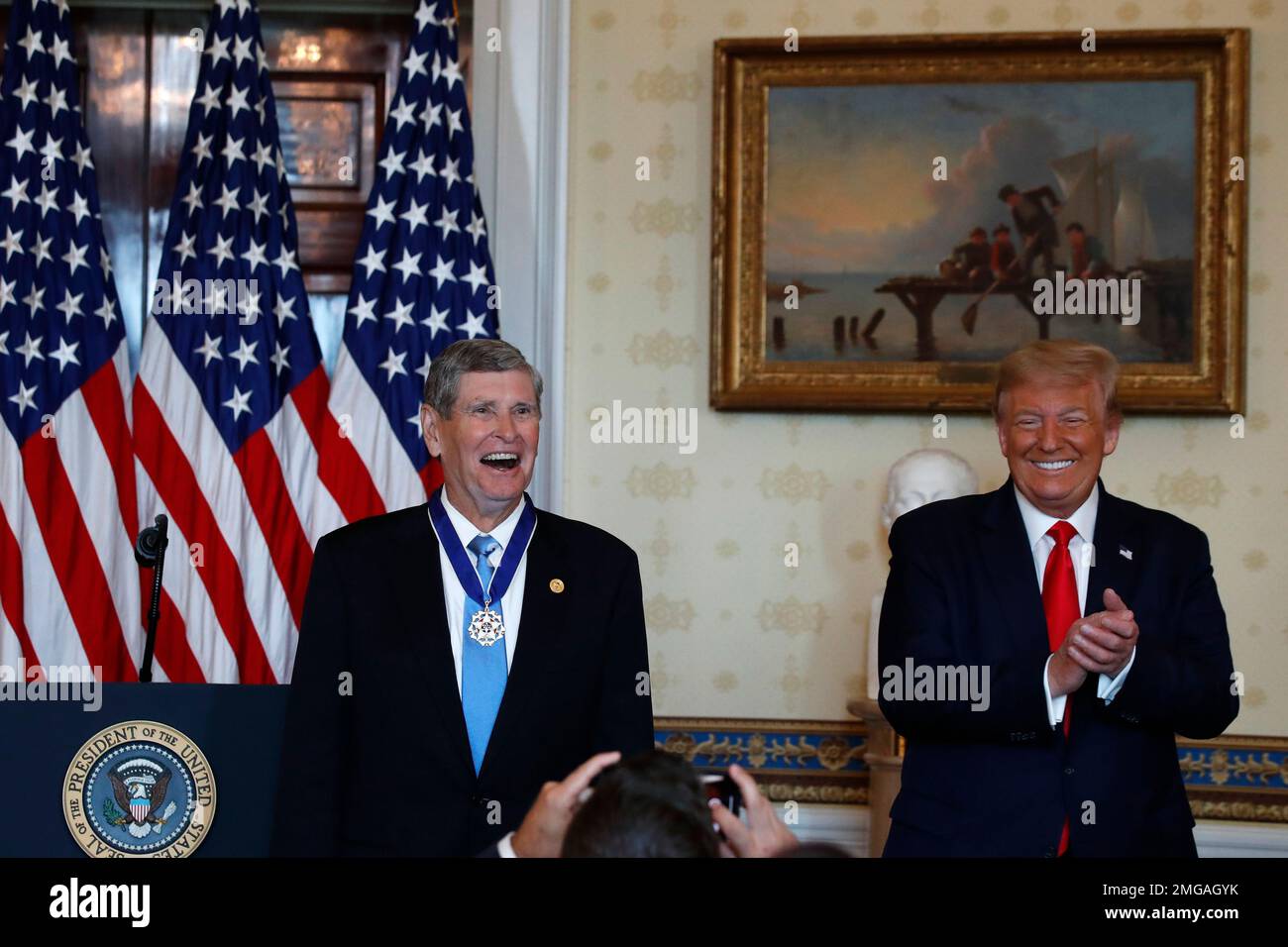 President Donald Trump and Jim Ryun react after Trump presented the