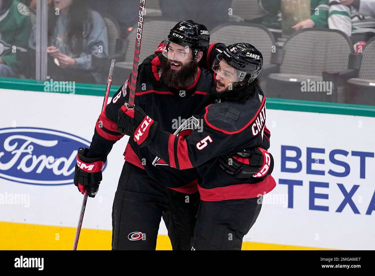 Carolina Hurricanes' Brent Burns (8) and Jalen Chatfield (5) celebrate