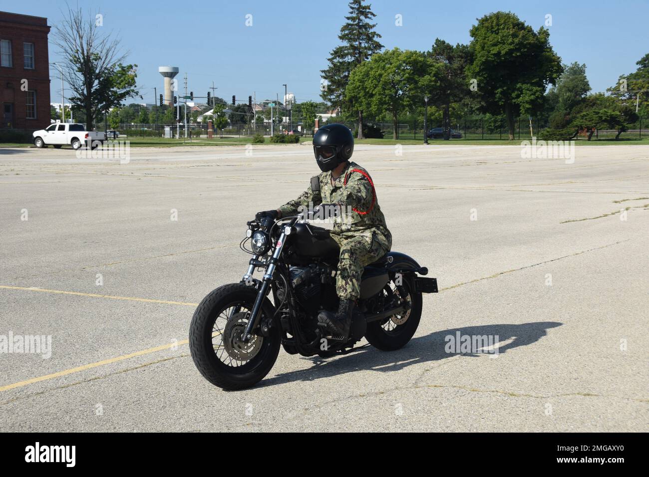 GREAT LAKES (Aug. 23, 2022) Chief Mineman Joshua Royer, a recruit division commander at the U.S. Navy's only boot camp, Recruit Training Command, participates in a motorcycle class in Camp Barry aboard Naval Station Great Lakes. Recruit Training Command and Naval Station Great Lakes Safety hosted American Motorcycle Training instructors to provide a total of five sessions of safety oriented rider training over three consecutive days August 22-24. Each session was three hours and accommodated up to 12 riders. Stock Photo
