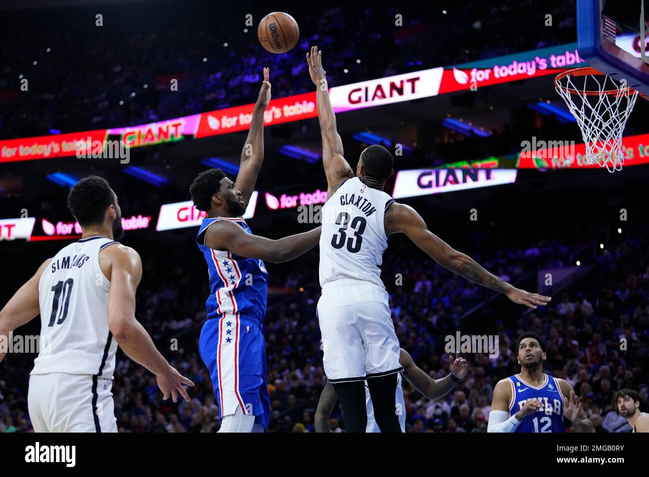 Philadelphia 76ers' Joel Embiid, left, goes up for a shot against
