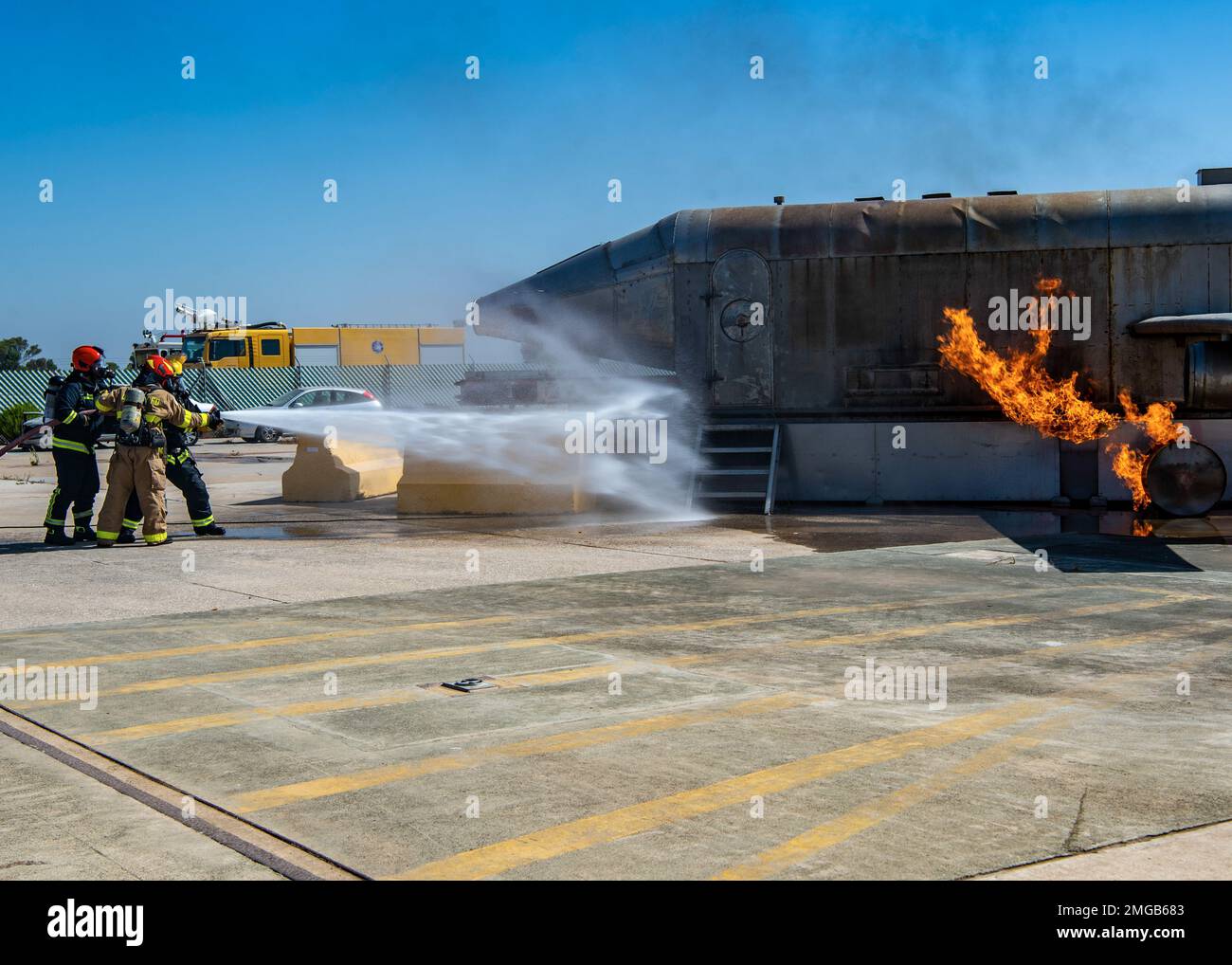 NAVAL STATION ROTA, Spain (Aug. 23, 2022) Naval Station (NAVSTA) Rota Fire and Emergency Services fight a fire from a simulated plane crash during a flight line emergency drill on NAVSTA Rota, Spain, Aug. 23, 2022. Naval Station Rota sustains the fleet, enables the fighter and supports the family by conducting air operations, port operations, ensuring security and safety, assuring quality of life and providing the core services of power, water, fuel and information technology. Stock Photo