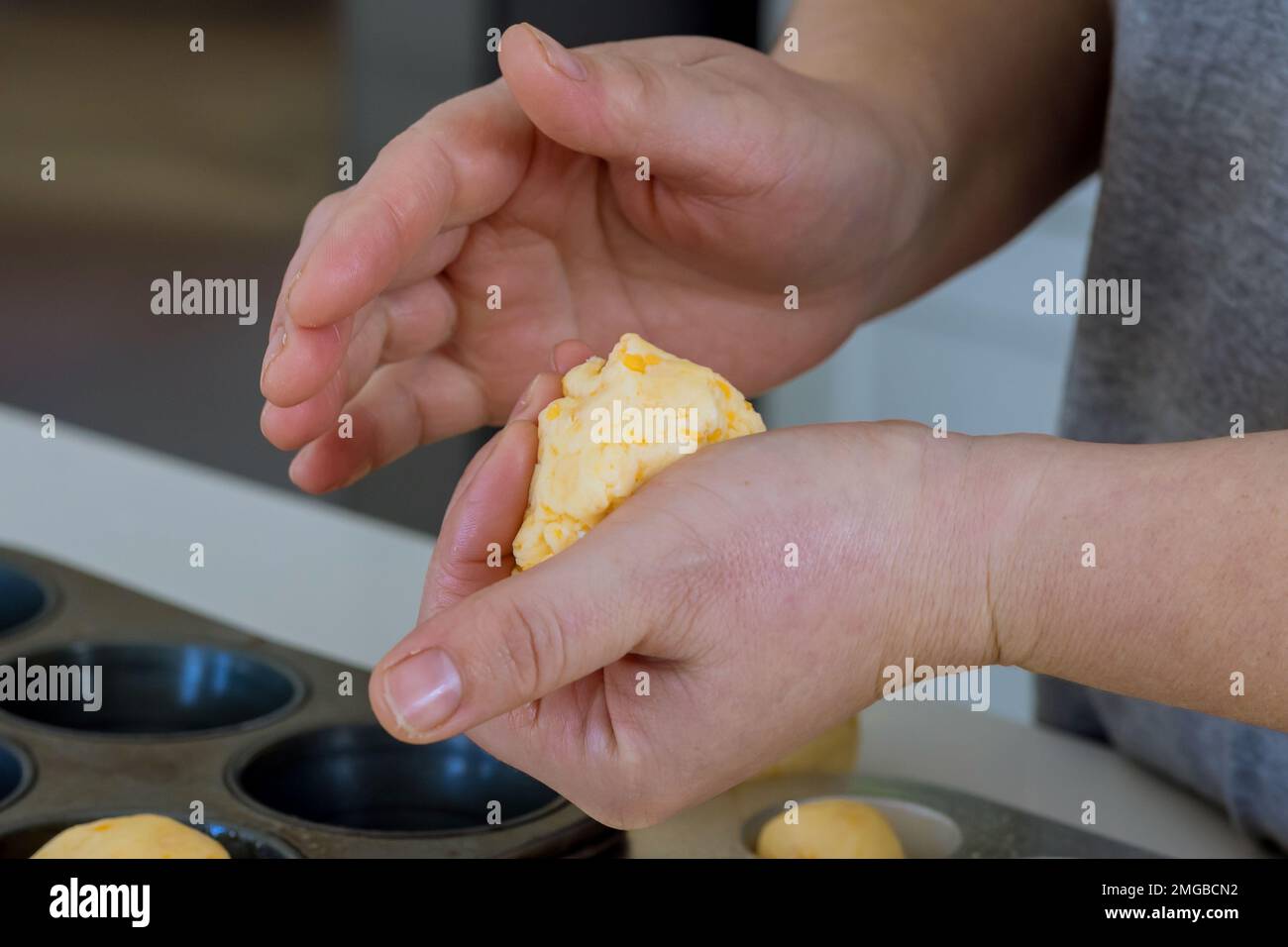 Traditionally, Brazilian cheese buns are used as snacks, but process of preparing baking them is homemade Stock Photo