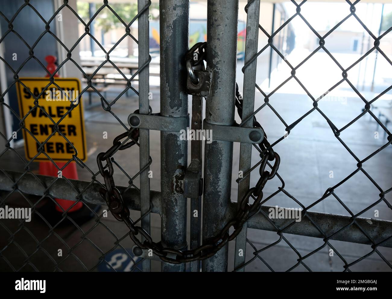 A chain link fence lock is see on a gate at a closed Ranchito Elementary  School in the San Franando Valley section of Los Angeles on Monday, July  13, 2020. Amid spiking