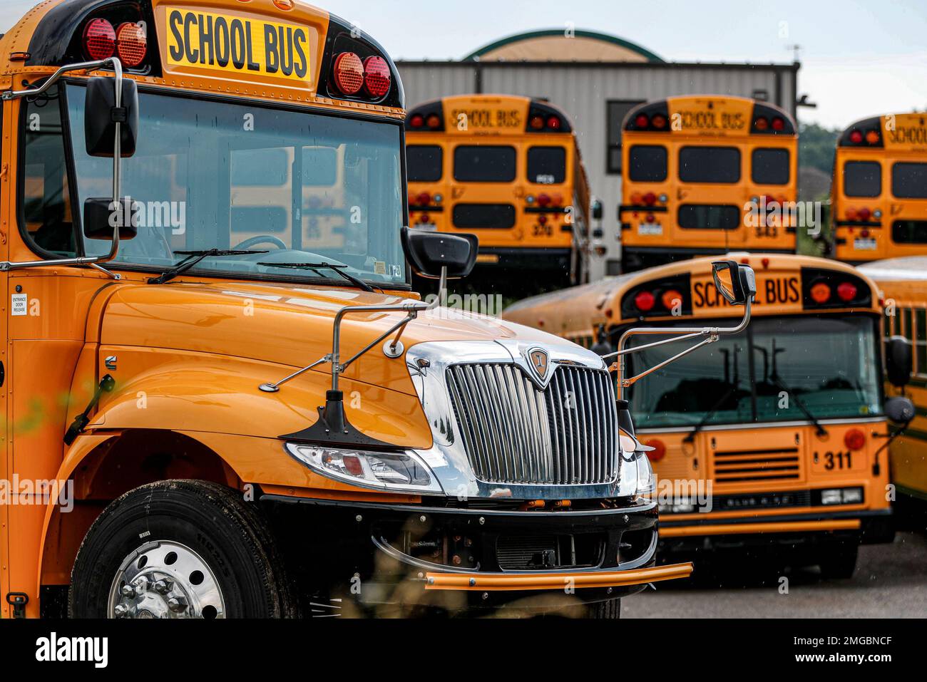 Rows of school buses are parked at their terminal, Friday, July 10