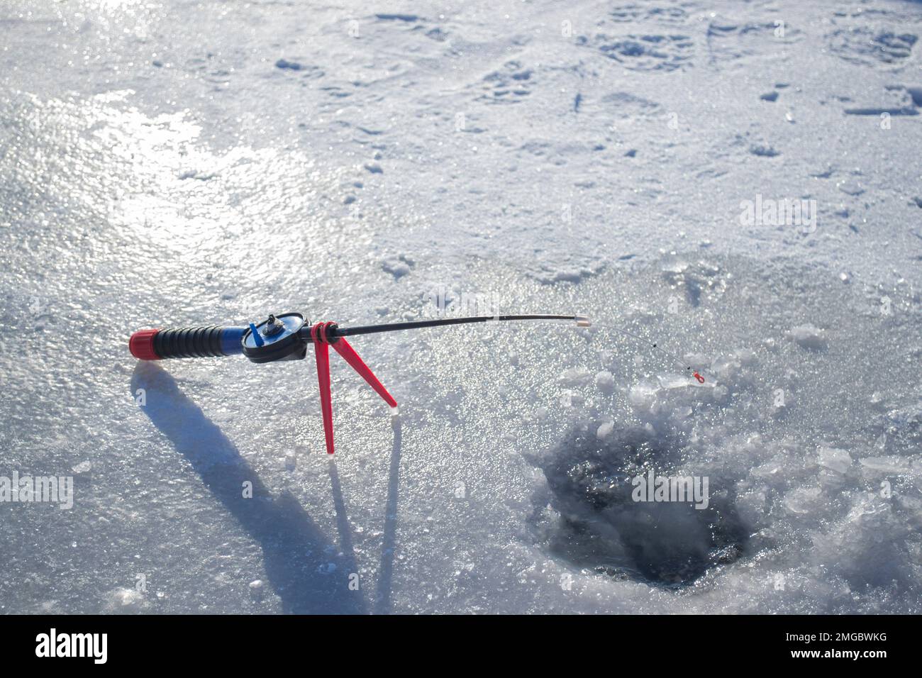 Winter ice fishing. Ice fishing in the winter. Small fishing rod