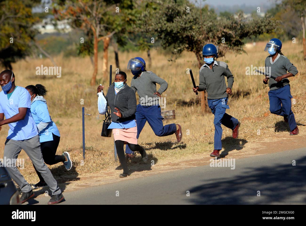 Riot police give chase to nurses who were protesting at a government ...
