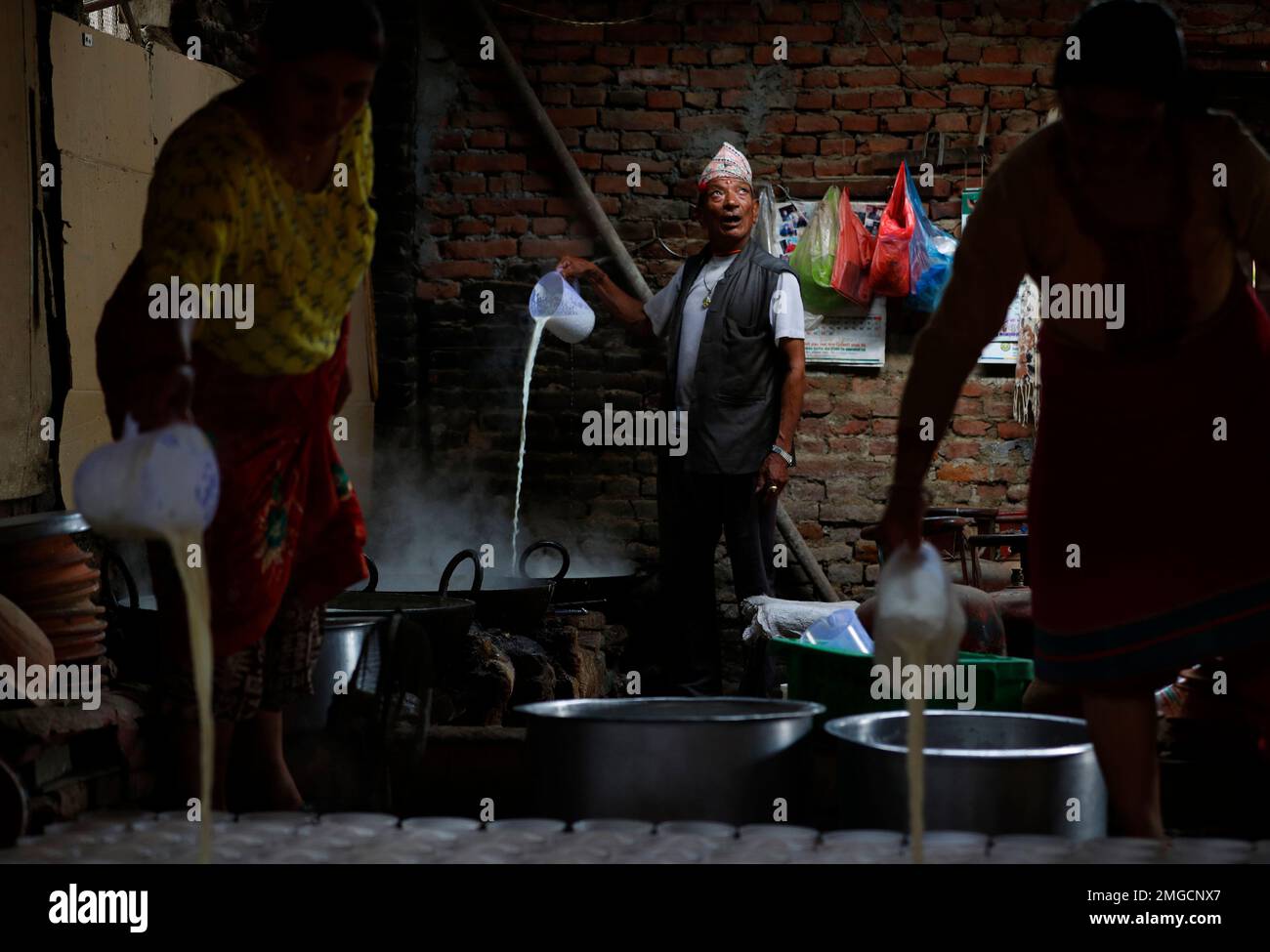 A traditional Nepalese yogurt maker boils milk to prepare yogurt during