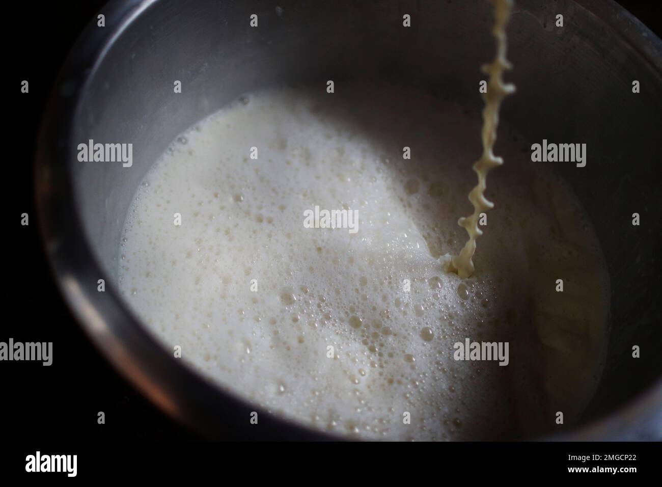 A traditional Nepalese yogurt maker boils milk to prepare yogurt during