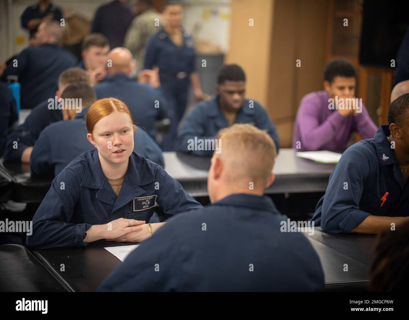 220823-N-OM737-2030  ATLANTIC OCEAN (August 23, 2022) Aviation Boatswain's Mate (Fuel) Airman Amber Meade, assigned to the Wasp-class amphibious assault ship USS Bataan (LHD 5), participates in a mentorship event on the ship’s mess decks, Aug. 23, 2022. Bataan is underway conducting an Afloat Training Group engineering inspection as part of the basic phase training cycle. Stock Photo