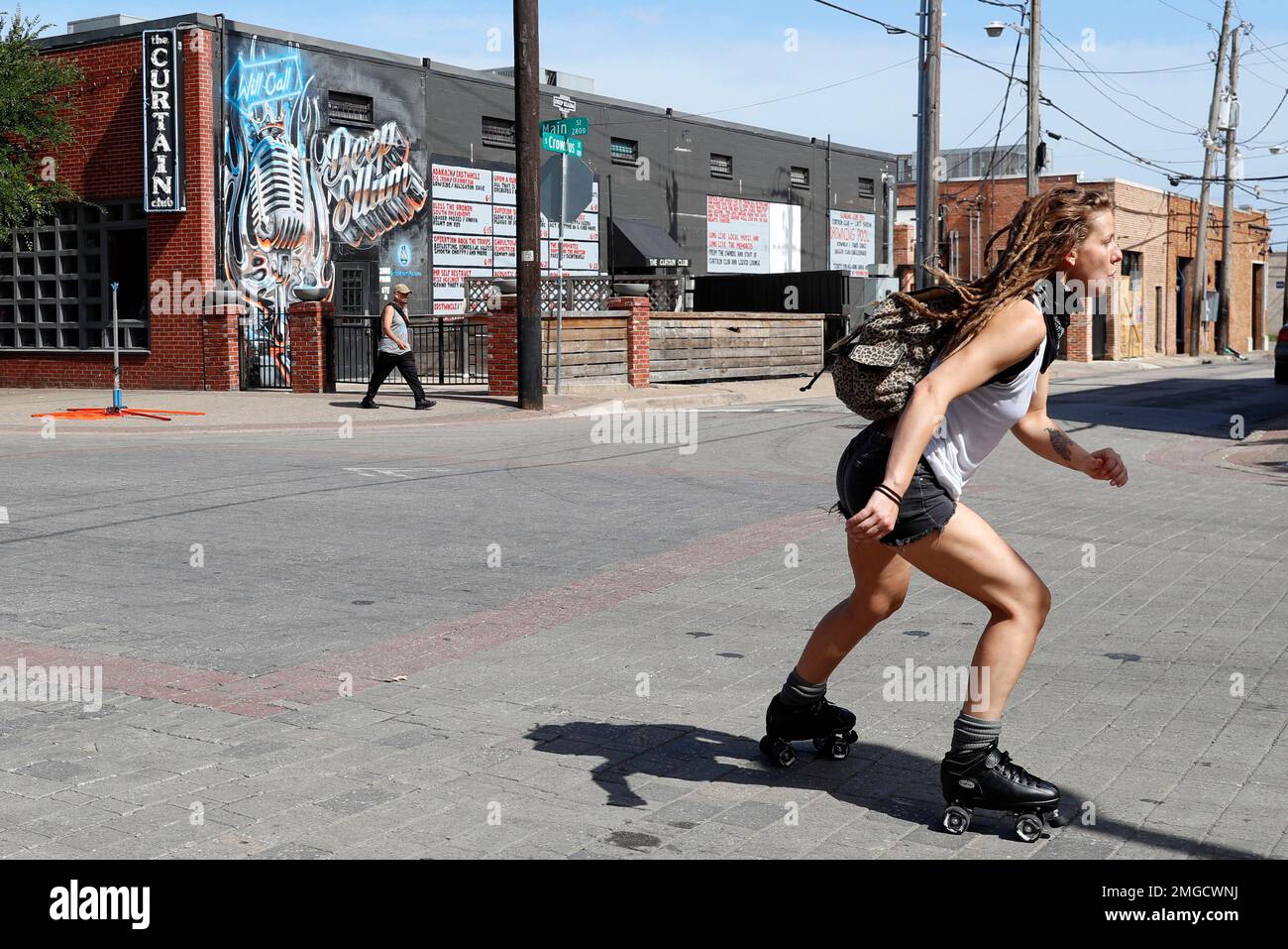 A woman skates through an intersection in the Deep Ellum entertainment district in Dallas, Friday, June 26, 2020. Deep Ellum is destination well known for its restaurants, cafes, tattoo shops and live A woman skates through an intersection in the Deep Ellum entertainment district in Dallas, Friday, June 26, 2020. Deep Ellum is destination well known for its restaurants, cafes, tattoo shops and live