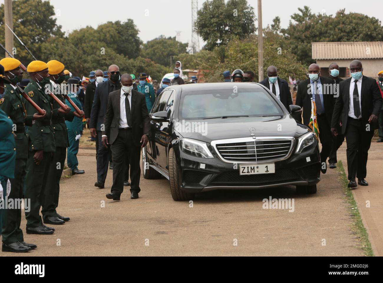 Zimbabwean President Emmerson Mnangagwa's vehicle is surrounded by bodyguards upon arrival for a State Funeral of a former military commander in Harare, Wednesday, June, 24, 2020. Mnangagwa attended the funeral of Stanely Nlyeya a liberation war hero who died on Tuesday. (AP Photo/Tsvangirayi Mukwazhi) Stock Photo