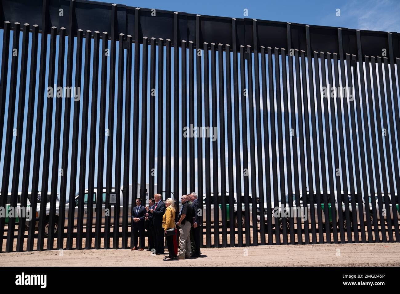 President Donald Trump poses for photos during a tour of a section of ...
