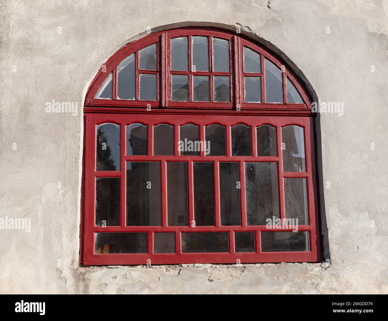 An old vintage wooden window with peeling paint oh frames needed to be