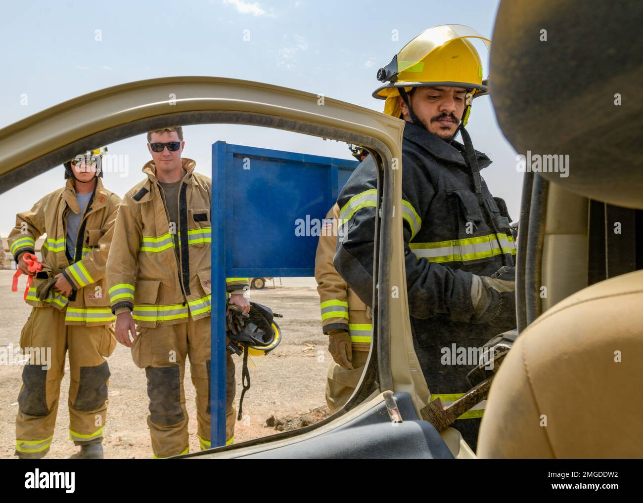 A Royal Saudi Air Force firefighter uses a hydraulicextrication rescue