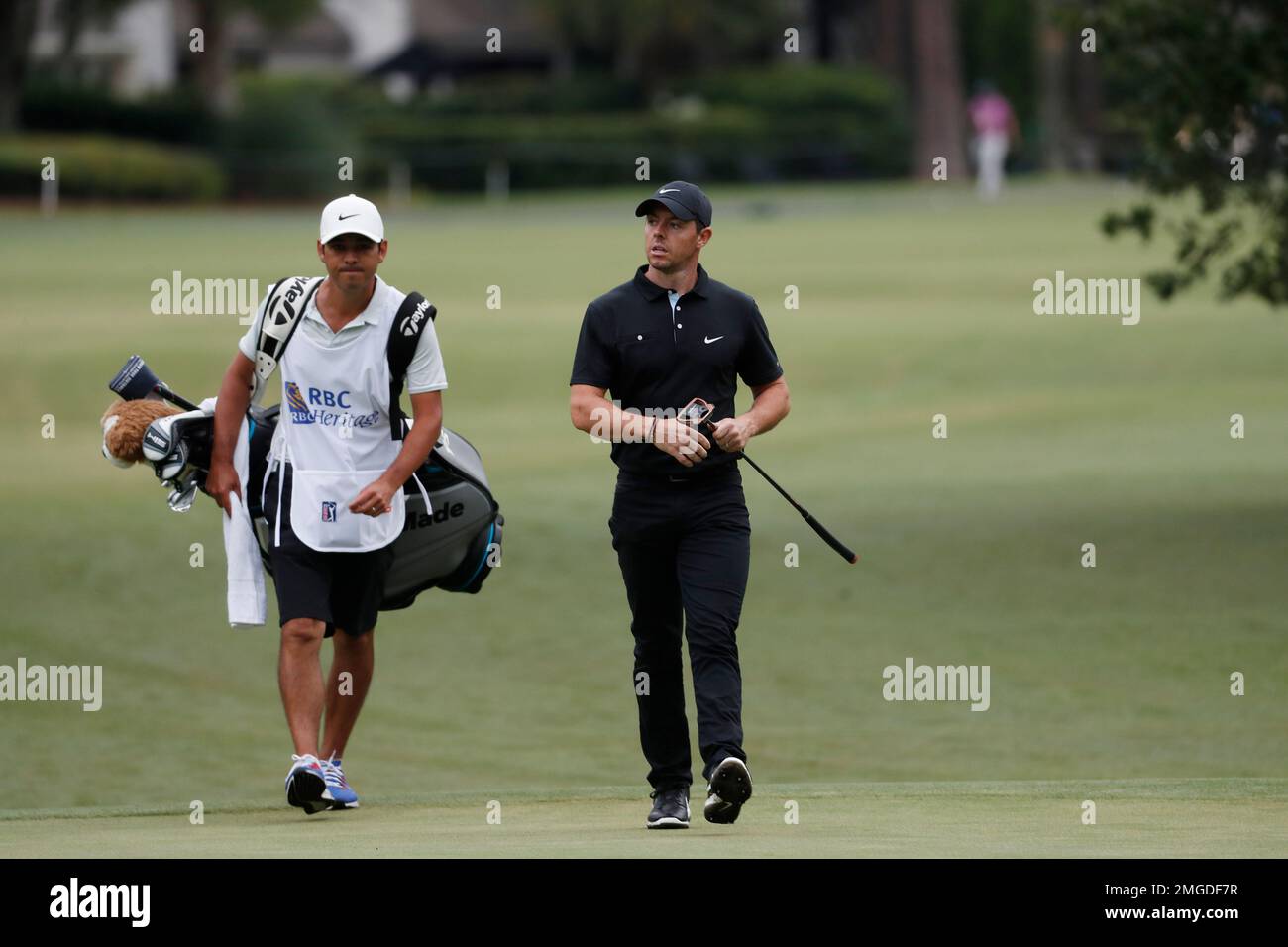 Rory McIIroy of Northern Ireland and his caddie walk up to the 10th