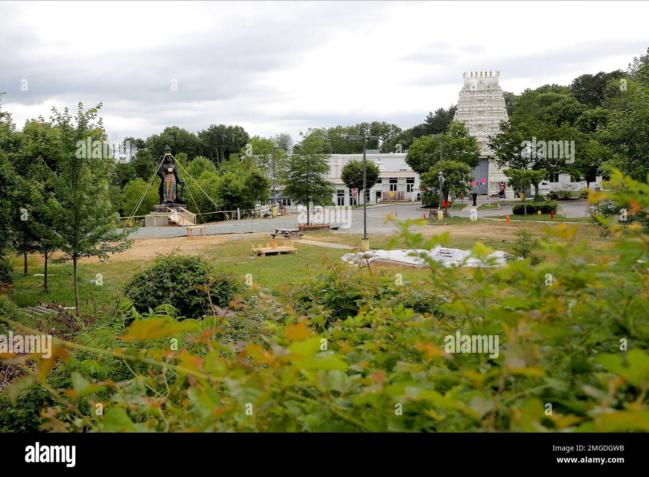 A statue of the Hindu god Hanuman, left, is seen on the grounds of the Hindu Temple of Delaware
