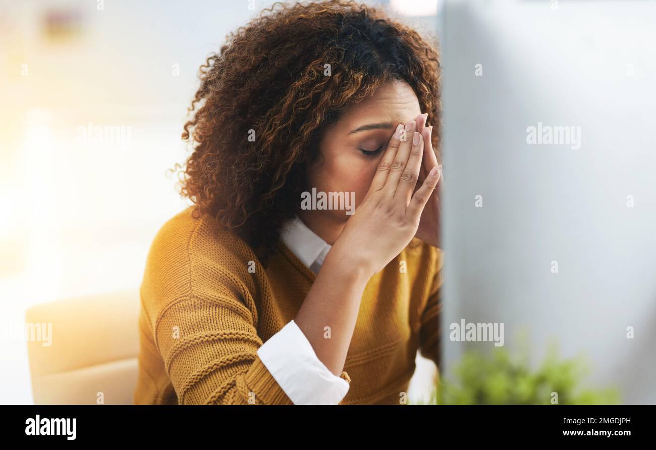 This is so frustrating. a stressed young businesswoman sitting and working in the office at work. Stock Photo
