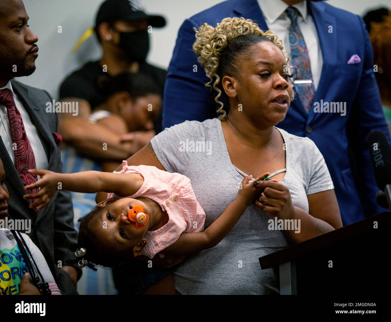 NO FILM, NO VIDEO, NO TV, NO DOCUMENTARY - Tomika Miller, the wife of  Rayshard Brooks, holds their daughter Memory, 2, while attorney Chris  Stewart speaks during the family press conference on