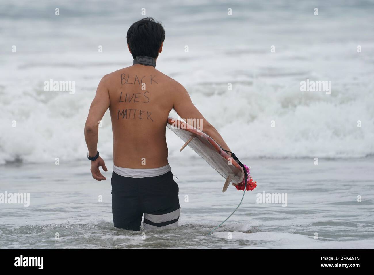 Panpan Wang participates in a paddle out ceremony at "The Ink Well," a ...