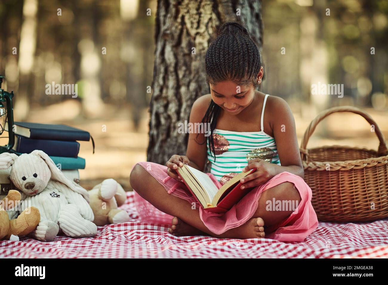 Brightening her imagination with books. a little girl reading a book