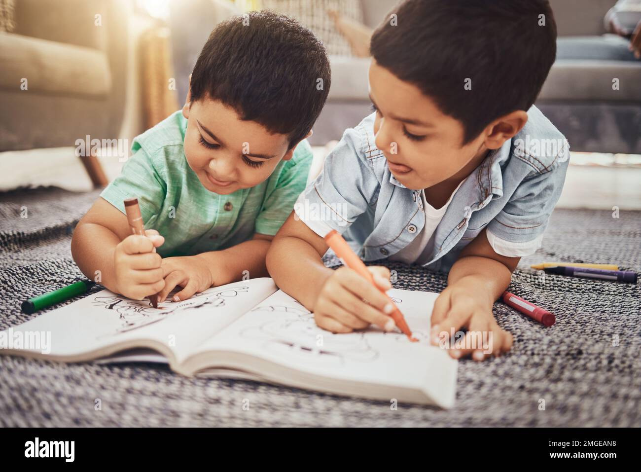 Kids, brothers and drawing while learning on floor at home, relax and